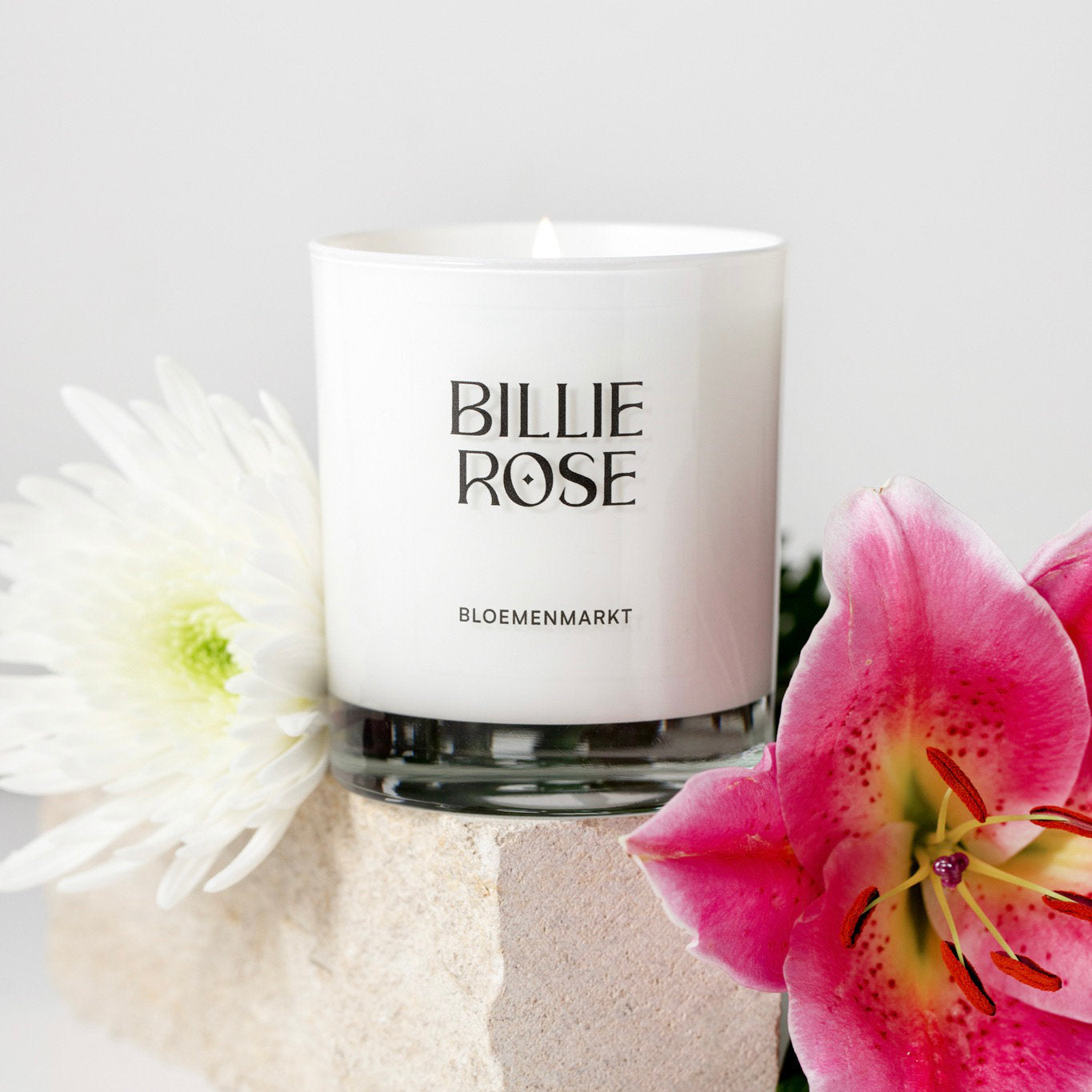 Billie Rose candle with flowers on a light background