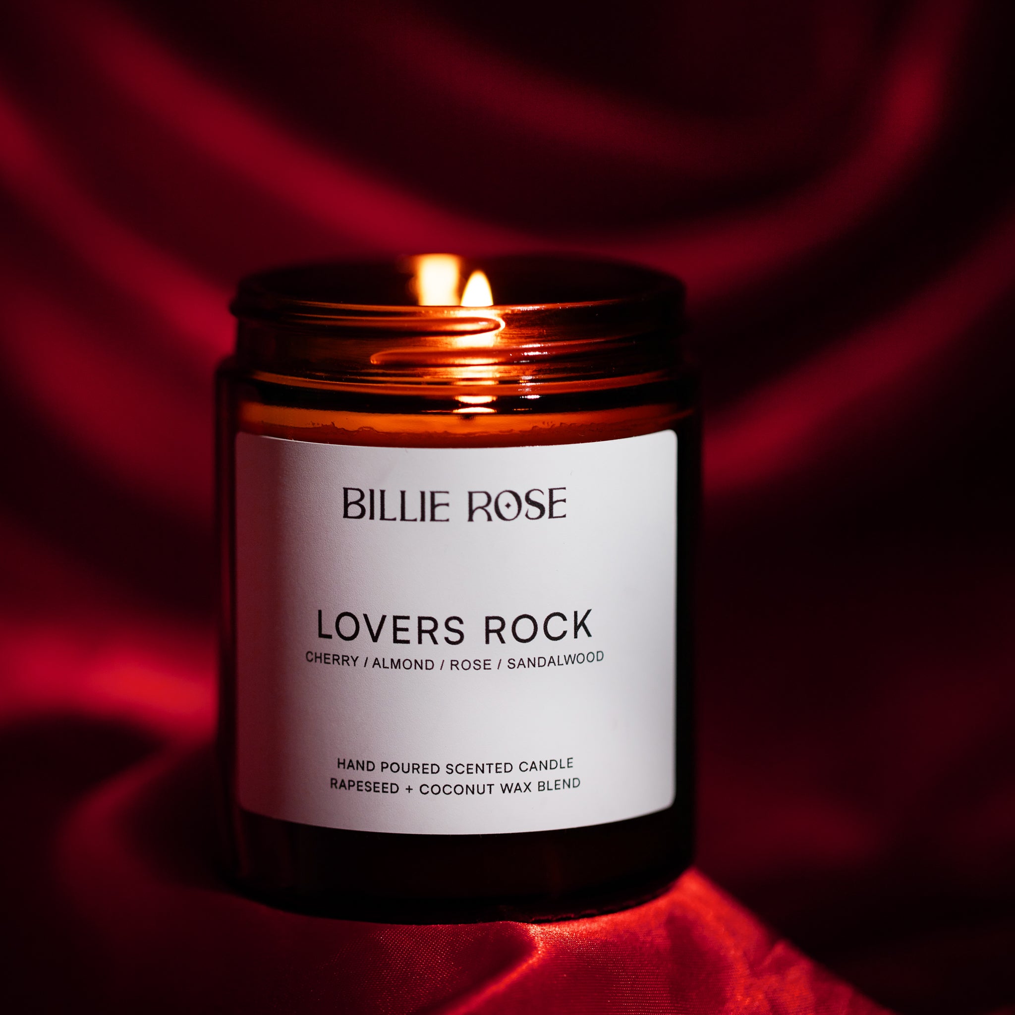 Lit candle on red background