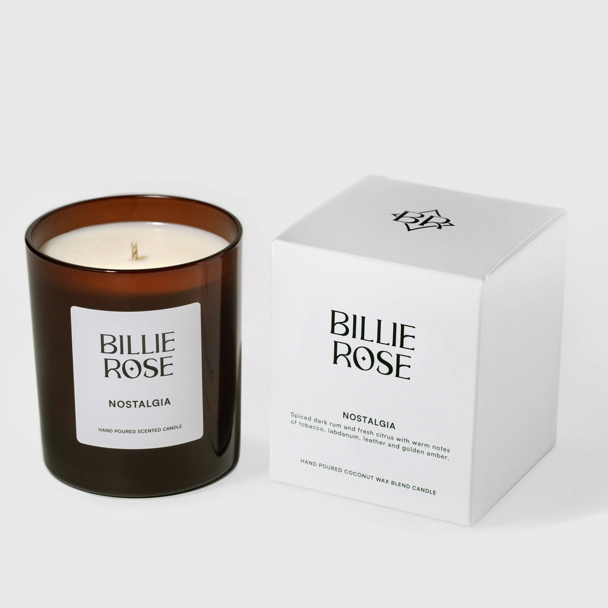 An amber glass jar candle labelled Billie Rose Evergreen next to its white product box on a light grey background.