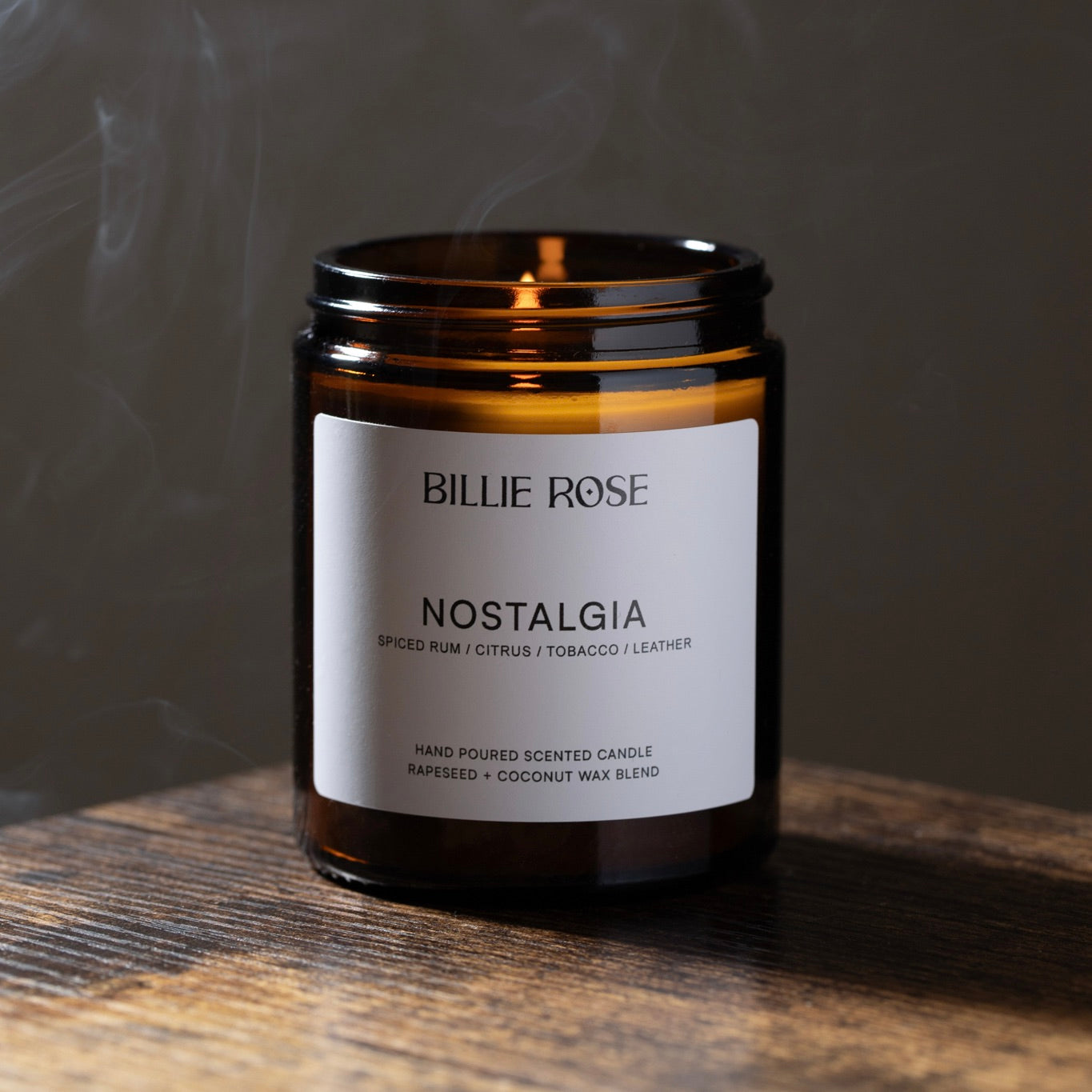 lit candle on dark smokey background