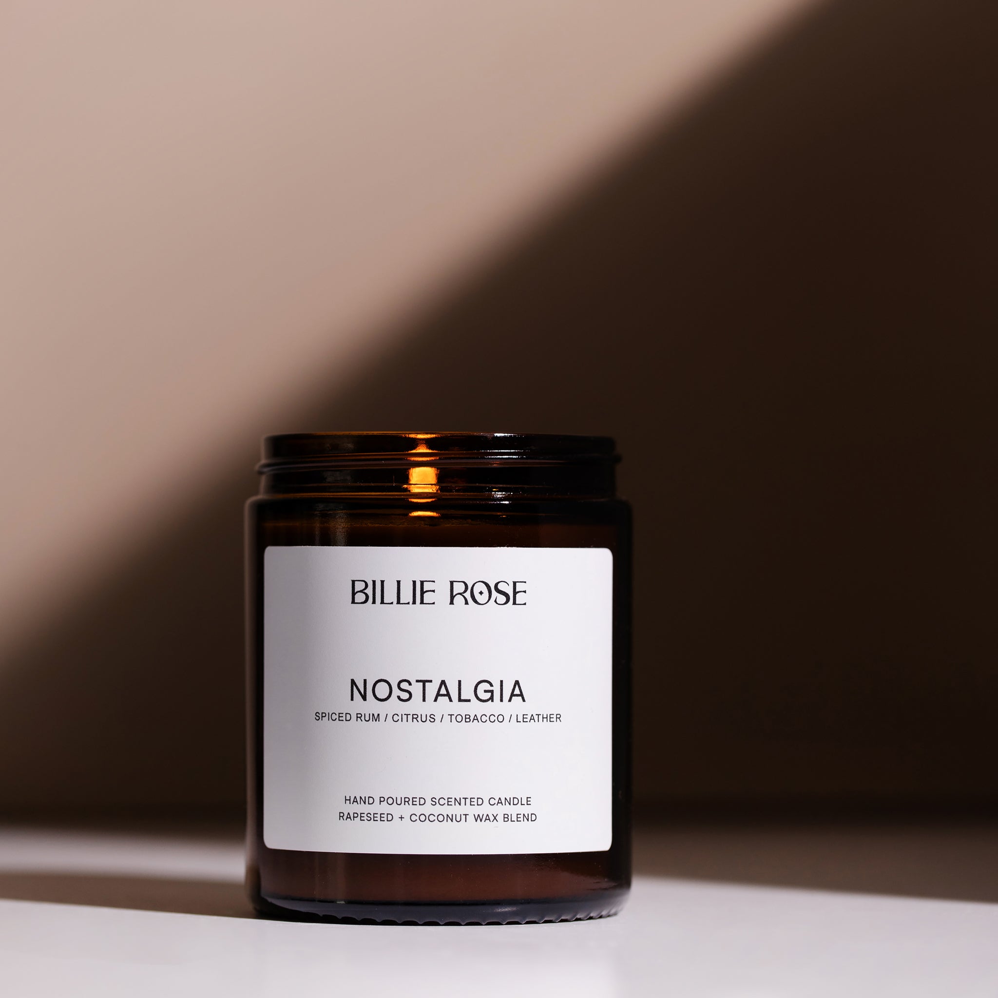 lit scented nostalgia candle on shadowy background