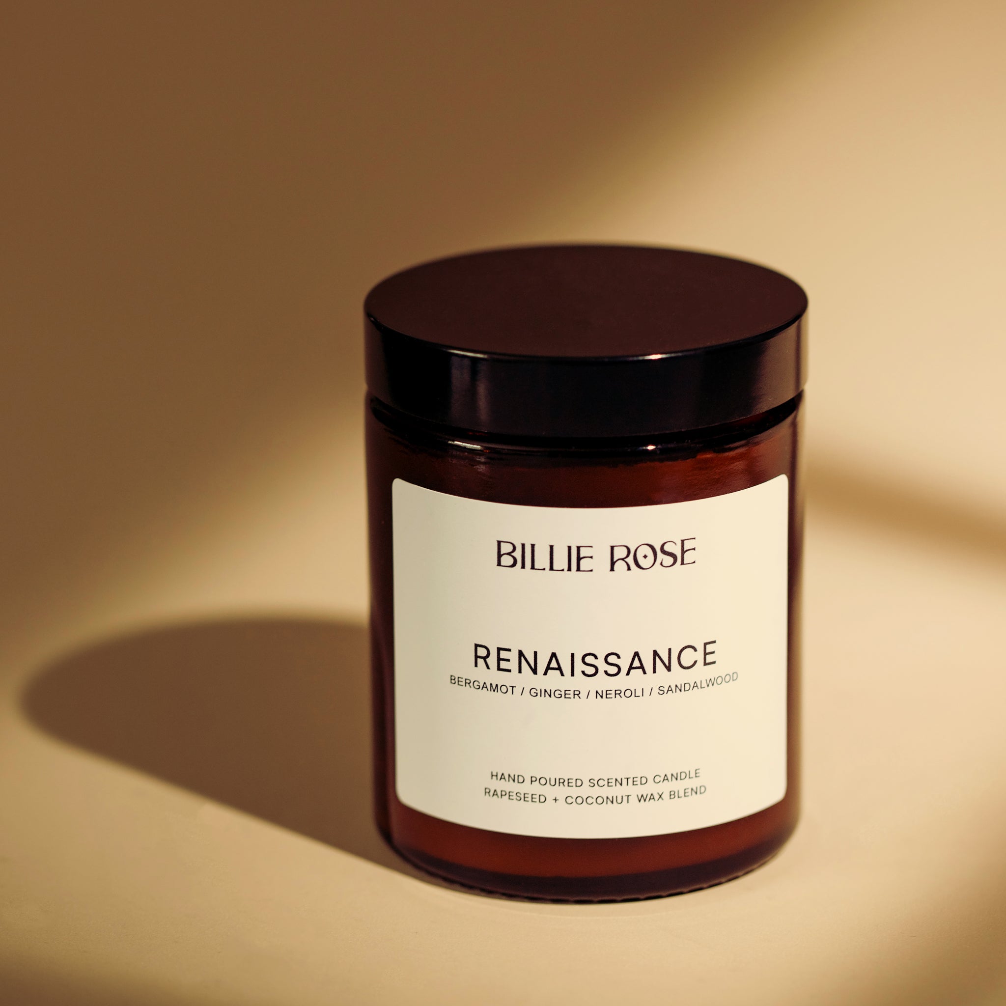 amber jar candle with lid on light shadowy background