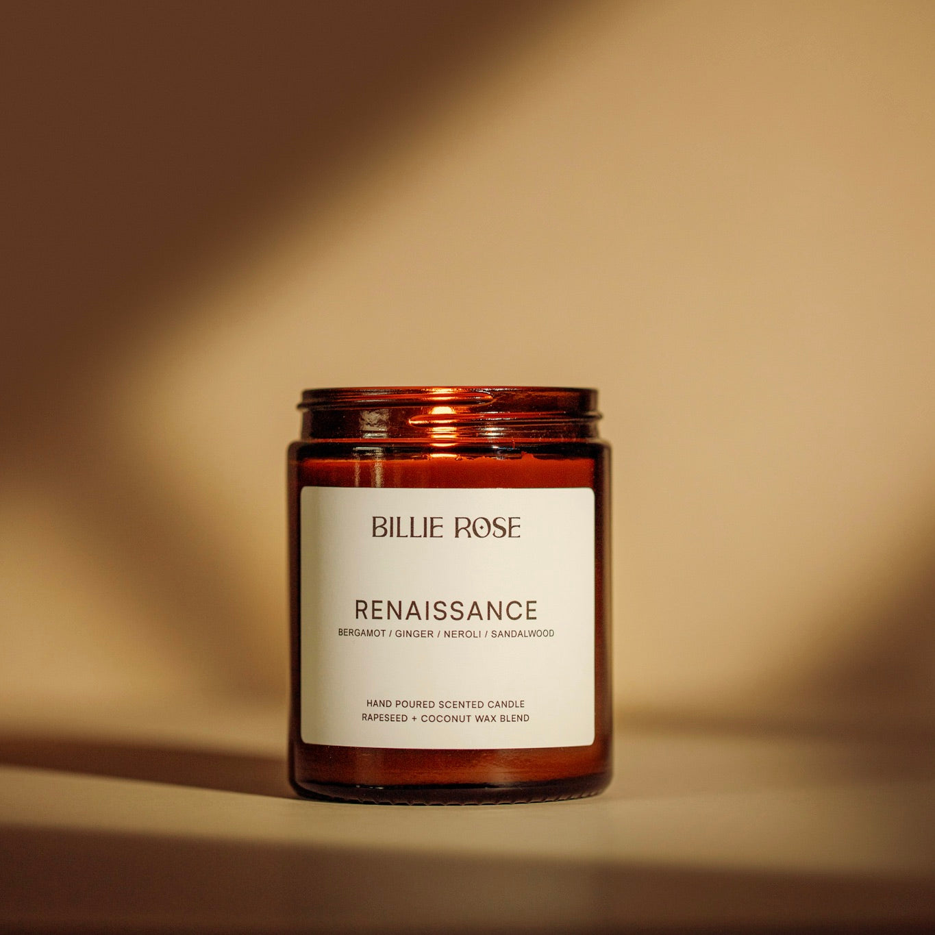 Candle jar labelled 'Billie Rose Renaissance' on a yellow beige background