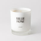 unlit candle in white glass jar on plain background
