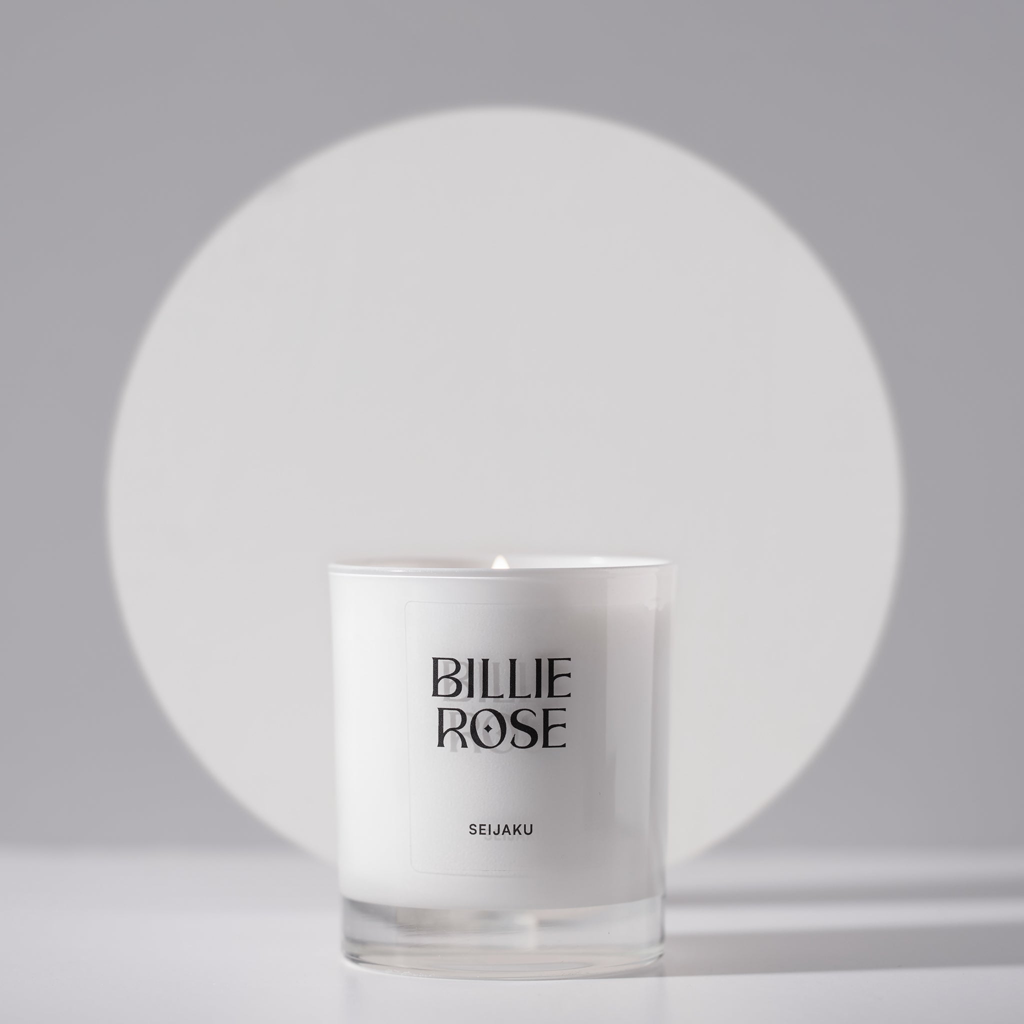 lit candle in white jar