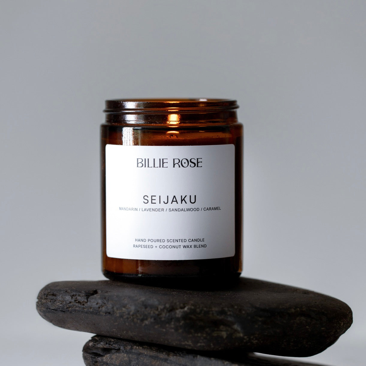 Brown candle labeled 'Seijaku' by Billie Rose on a gray background