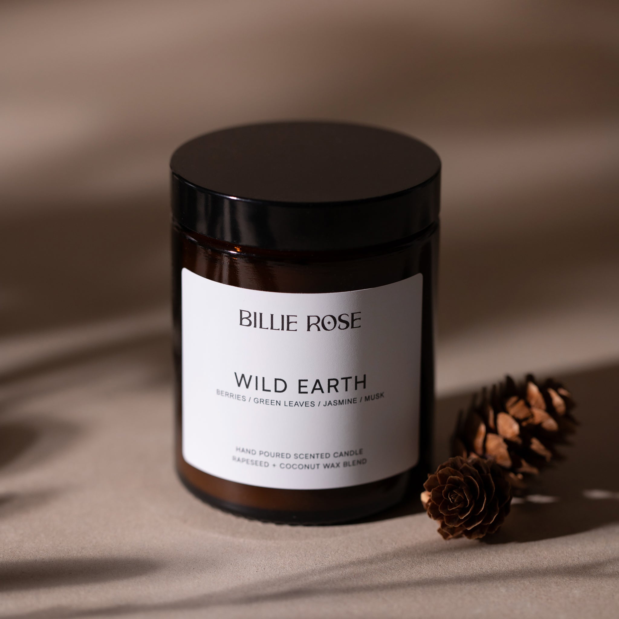 scented candle with lid on earthy brown background