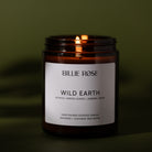 Candle labelled 'Billie Rose Wild Earth' with a green background