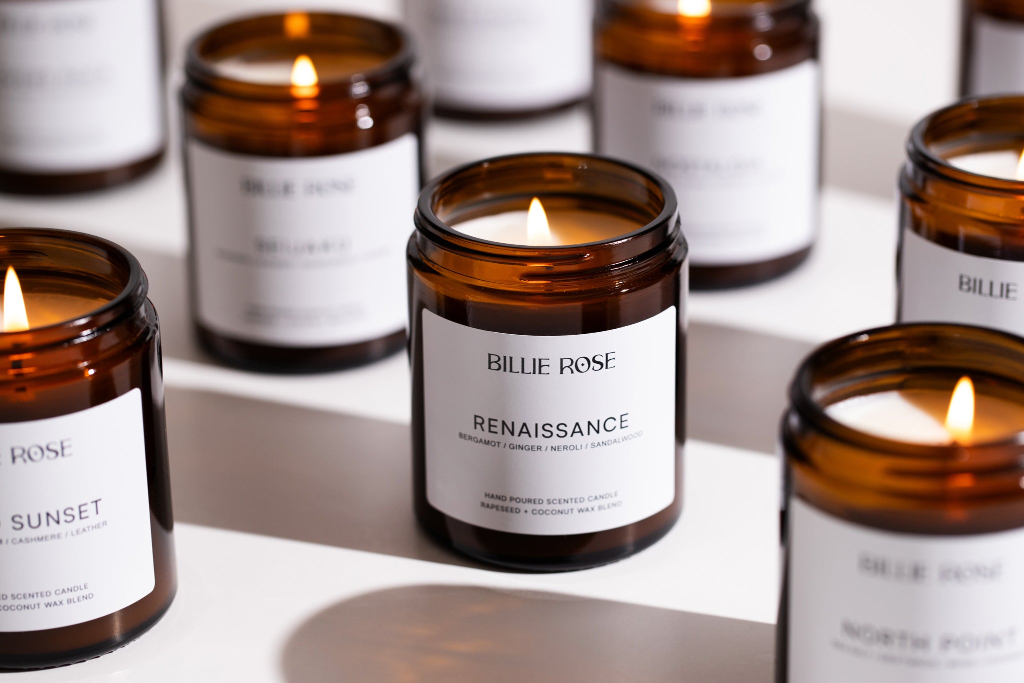 Display of  lit amber jar candles 