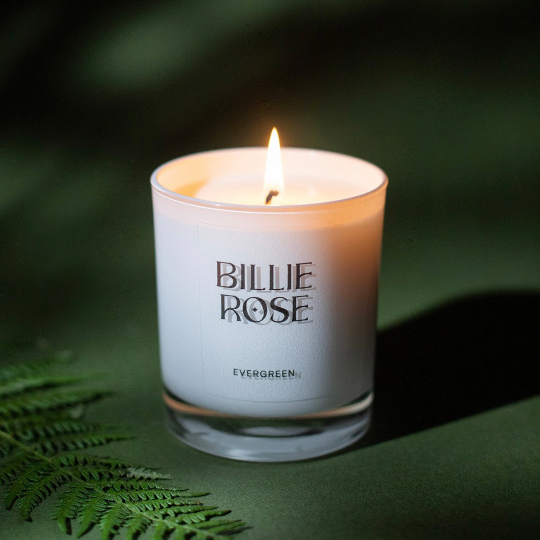 Candle with 'Billie Rose' branding on a green background
