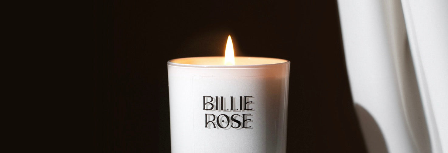 Candle with 'Billie Rose' branding on a dark background