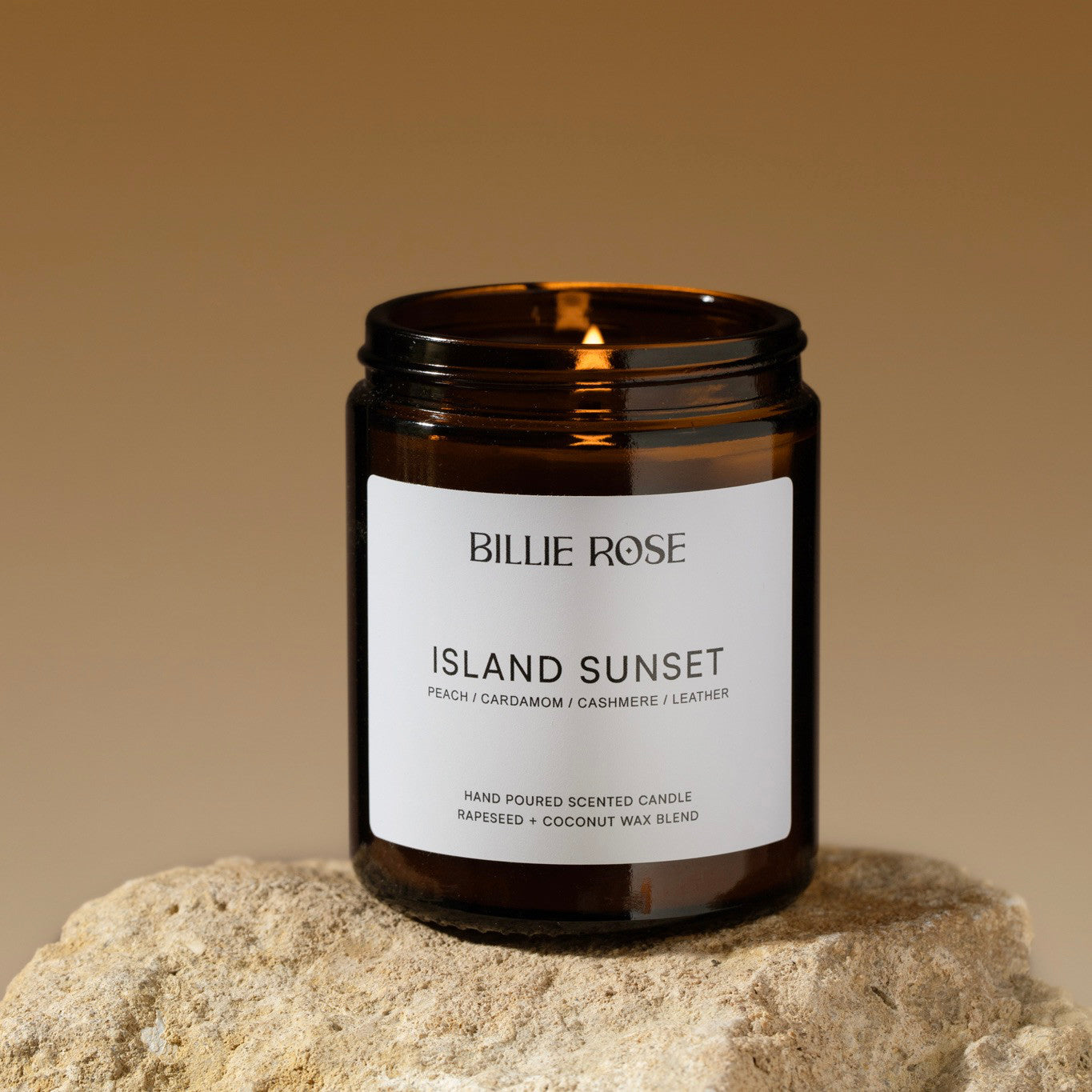 lit candle on rock and sunset style background