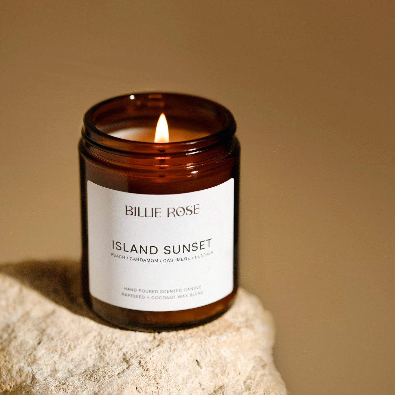 Billie Rose lit candle on rock and sunset style background