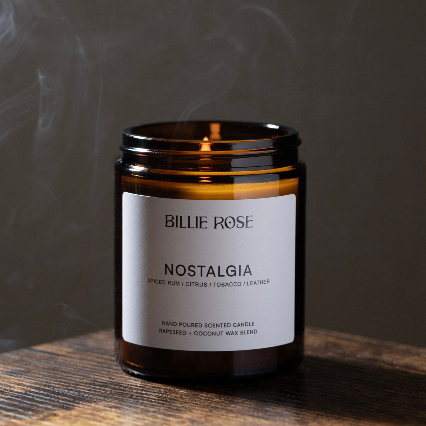 Candle with 'Billie Rose Nostalgia' label on a wooden surface