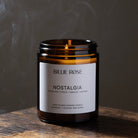 Candle with 'Billie Rose Nostalgia' label on a wooden surface