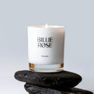 Seijaku candle in white jar sitting on pebbles