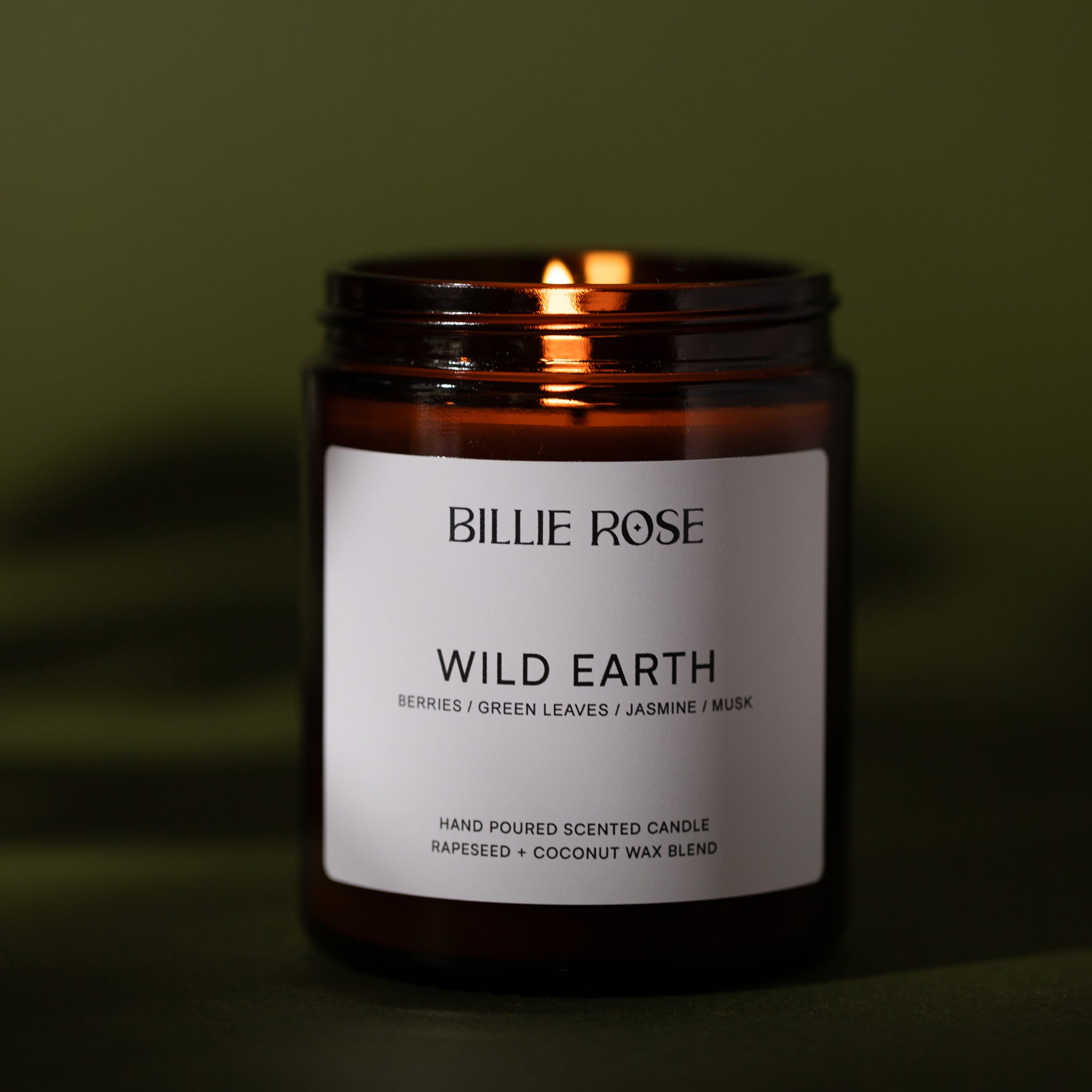Candle labelled 'Billie Rose Wild Earth' with a green background