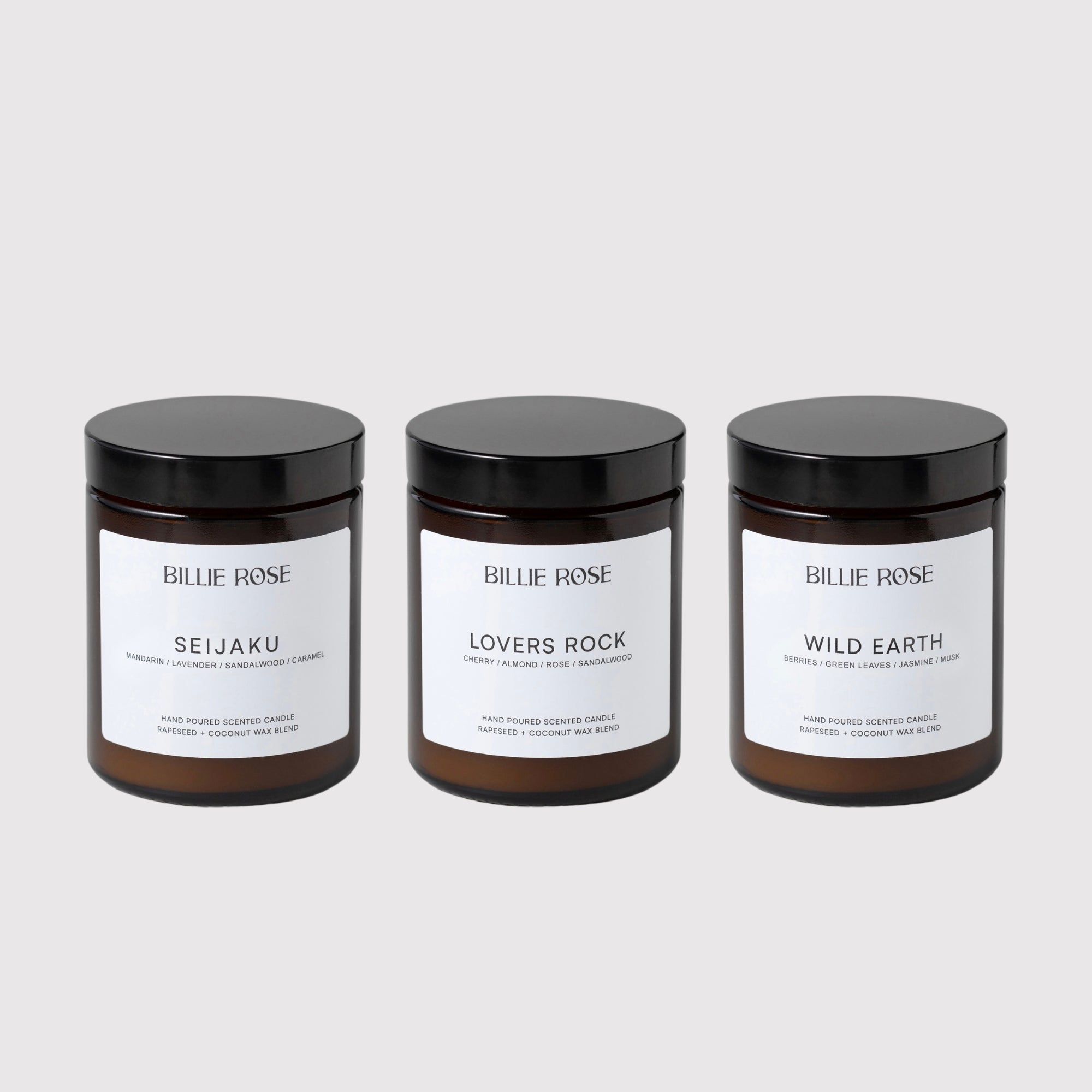 Three 'Billie Rose' candles with black lids on a grey background