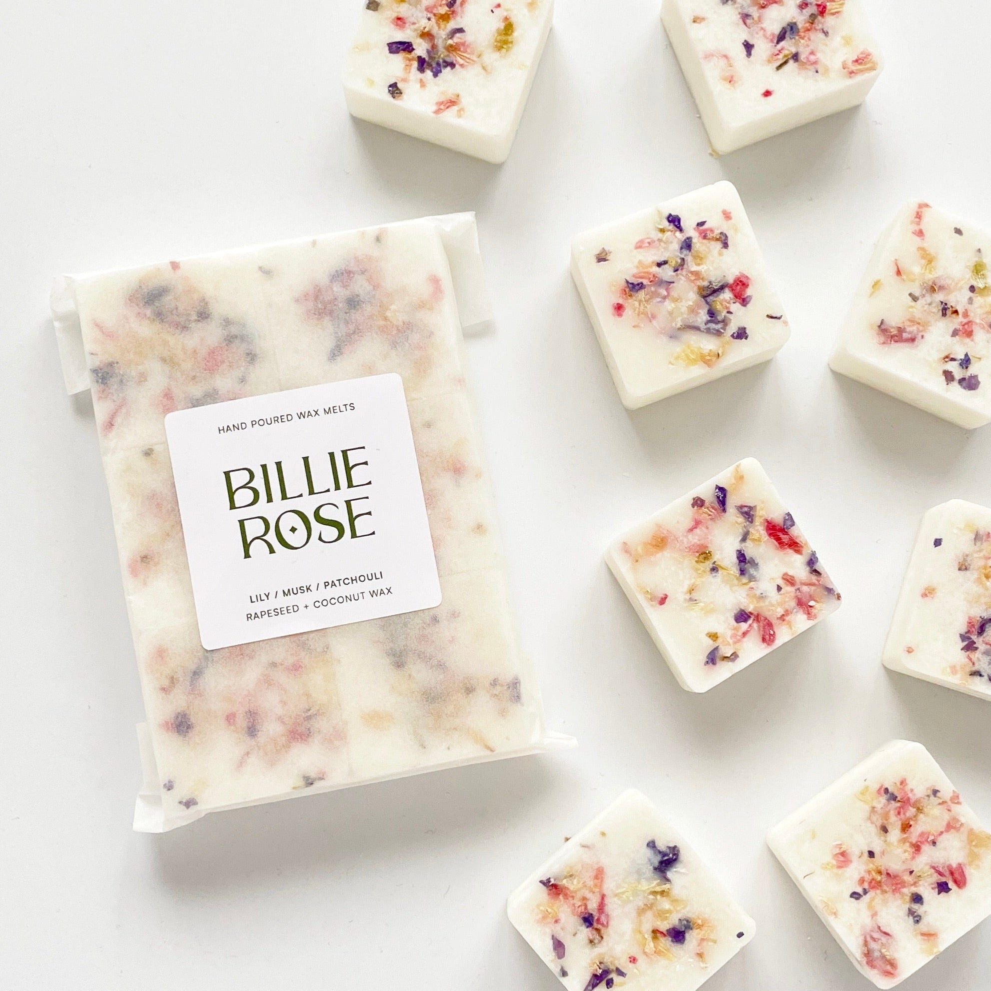 packet of wax melts and loose wax melts decorated with dried botanicals