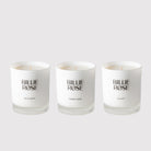 Three Billie Rose candles on a grey background